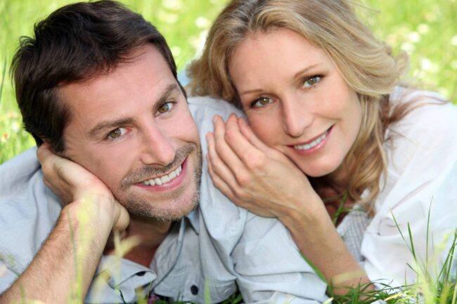 bigstock-Happy-couple-lying-on-grass-31172741