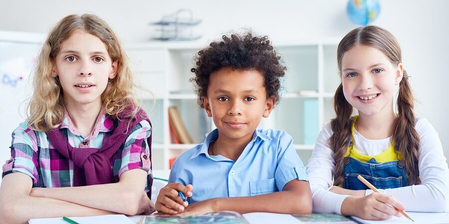 Three skilled children working in group at lesson