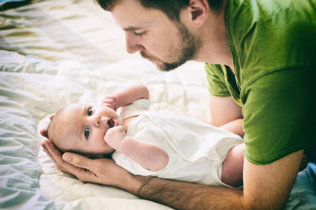 bigstock-Father-And-Child-On-A-White-Be-234355618