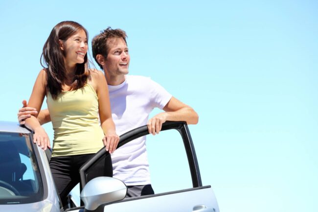 bigstock-Happy-couple-with-car-Young-i-18675608