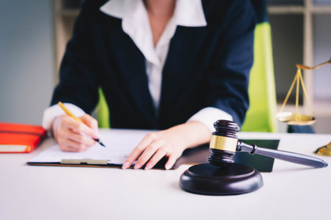 Judge Gavel On The Wooden Table Background With With Scales Of J