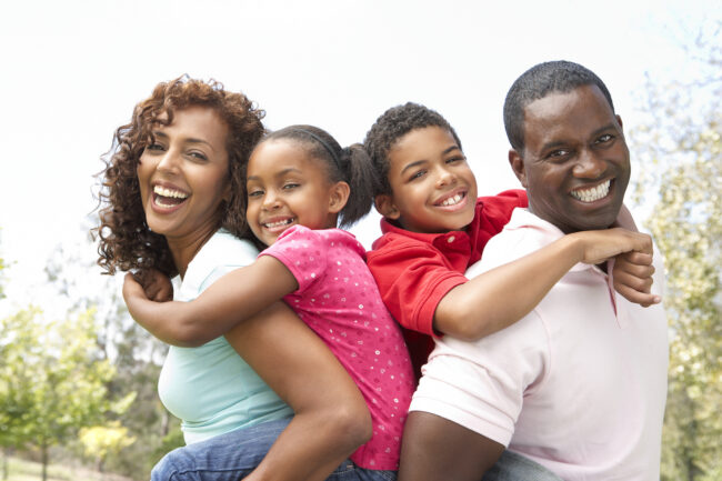 Portrait Of Happy Family In Park