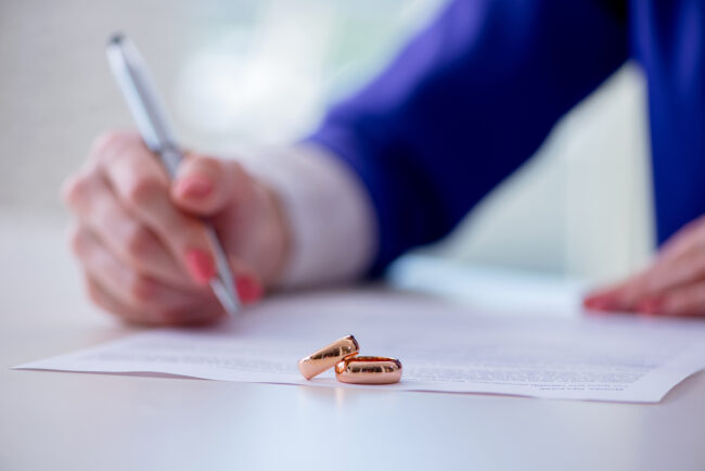 Woman signing prenuptial agreement in court