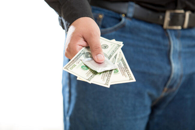 Photo Of Young Man Paying For Prostitute Service