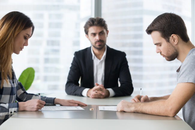 Spouses Couple Signing Decree Papers Getting Divorced In Lawyers