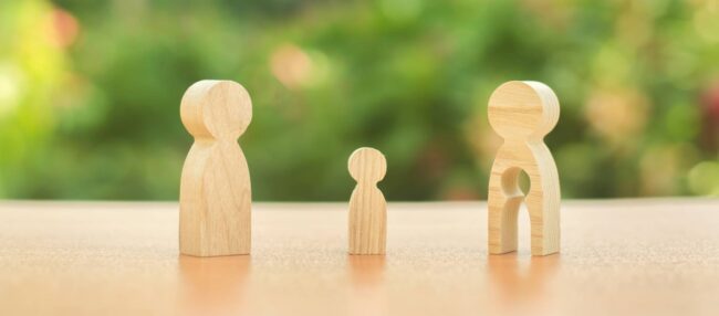 bigstock-Child–s-Figure-Stands-Betwee-310544992