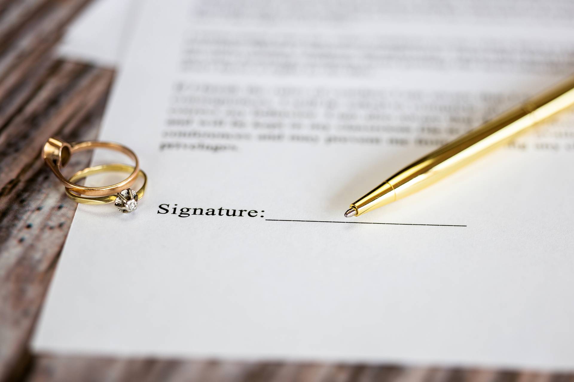 bigstock-Marriage-Contract-With-Two-Gol-414312338