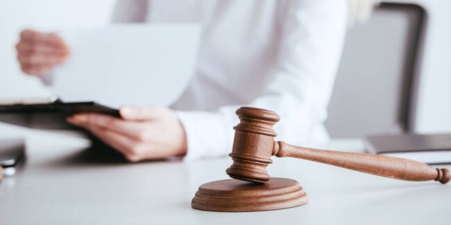 selective-focus-of-gavel-near-woman-holding-clipbo-2021-08-30-01-47-10-utc